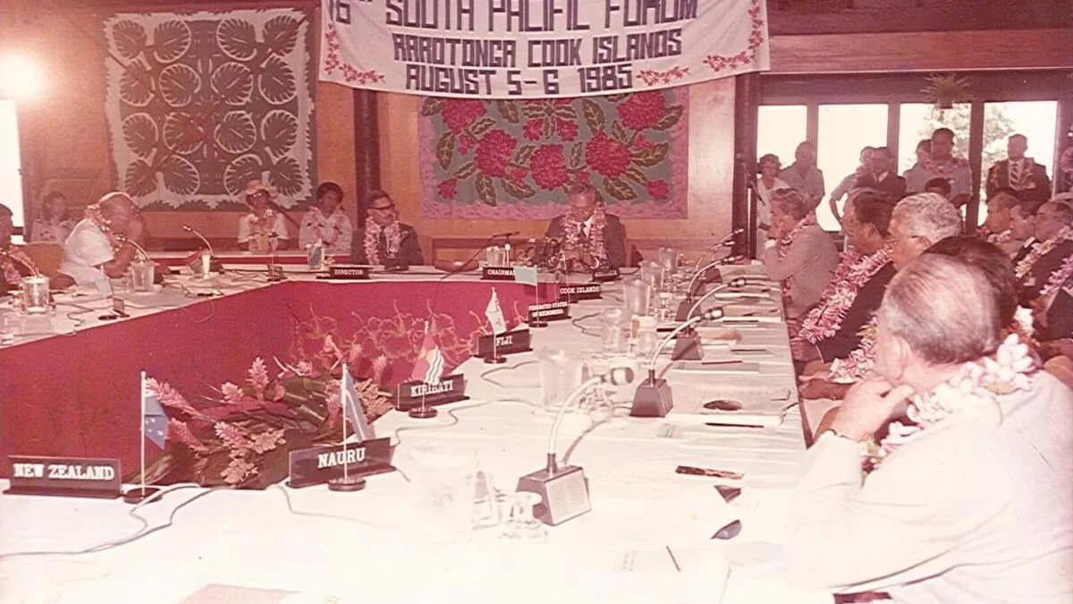 A conference room filled with delegates seated around a U-shaped table, with numerous Pacific country name holders displayed at each seat.